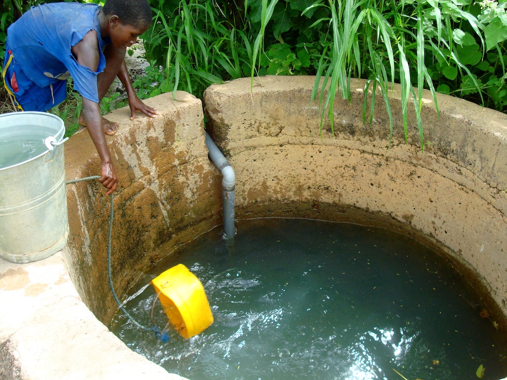 Rainwater catchment basins raise the water table, enabling villagers to tap local wells.