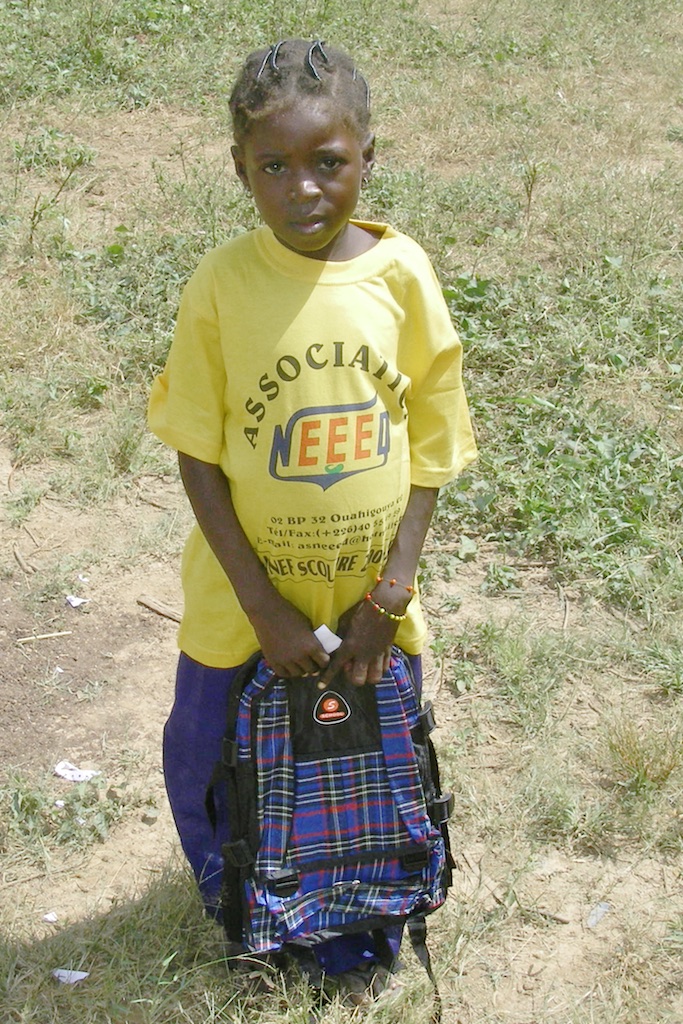 New student with school supplies ready to enter primary school.