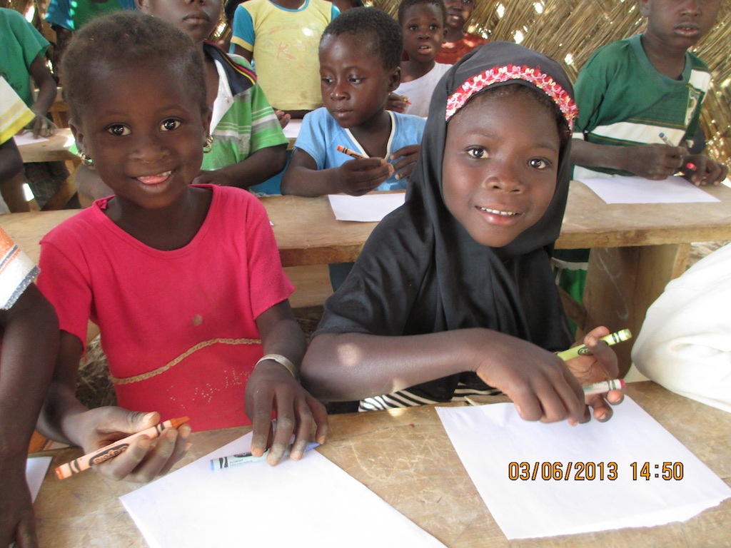Children thrilled to receive crayons and a sheet of paper.