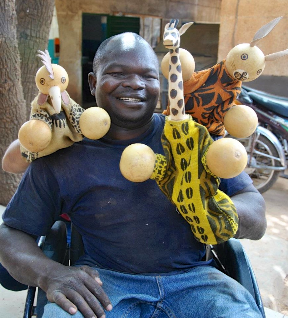Evariste and the wooden children's puppets he makes.