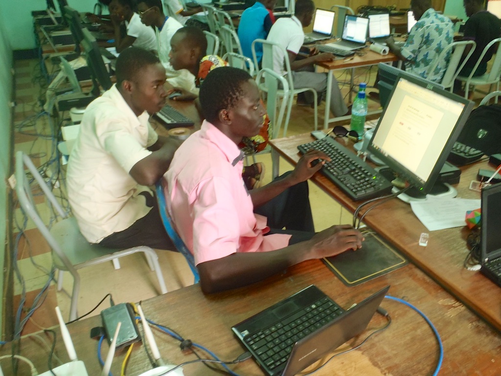 Instructor Stephane and student Herman Nebie review lesson plans.