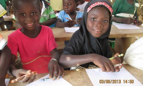 Children thrilled to receive crayons and a sheet of paper.