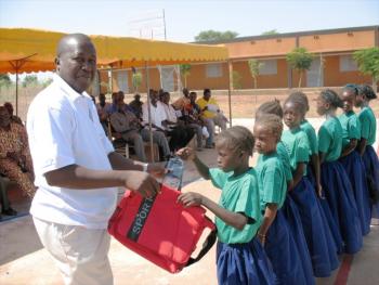 Director of Association NEEED delivering supplies to incoming students.