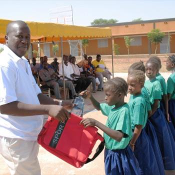 Director of Association NEEED delivering supplies to incoming students.