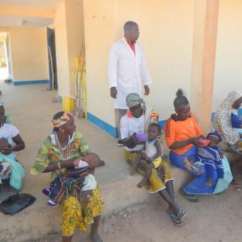 Feeding enriched porridge to children at the Nebrou health center